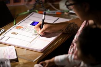 Image of person writing a note in a calendar